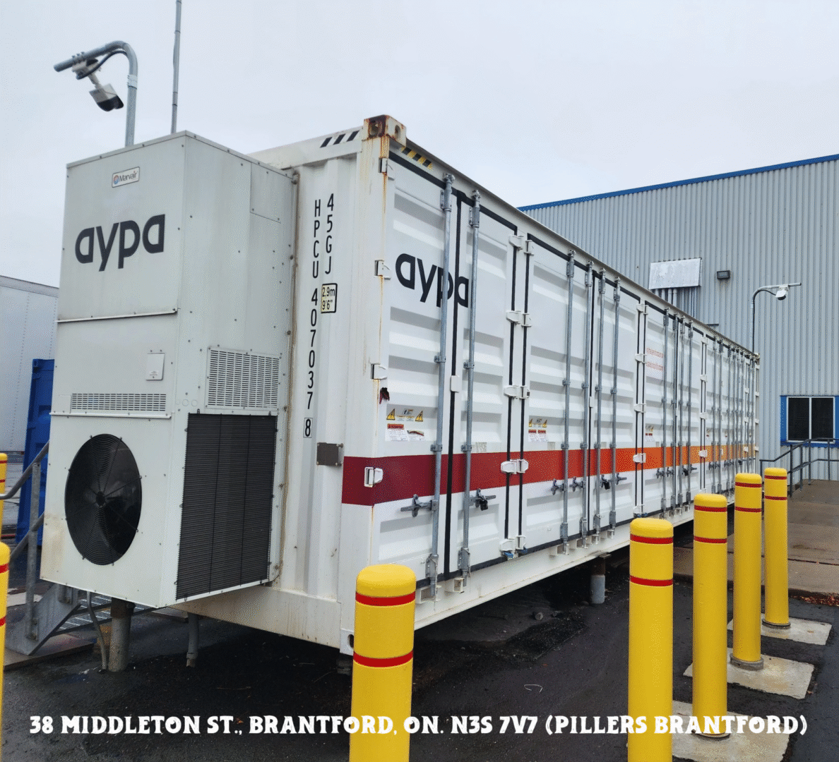 Large refrigerated truck parked outside a warehouse loading dock.