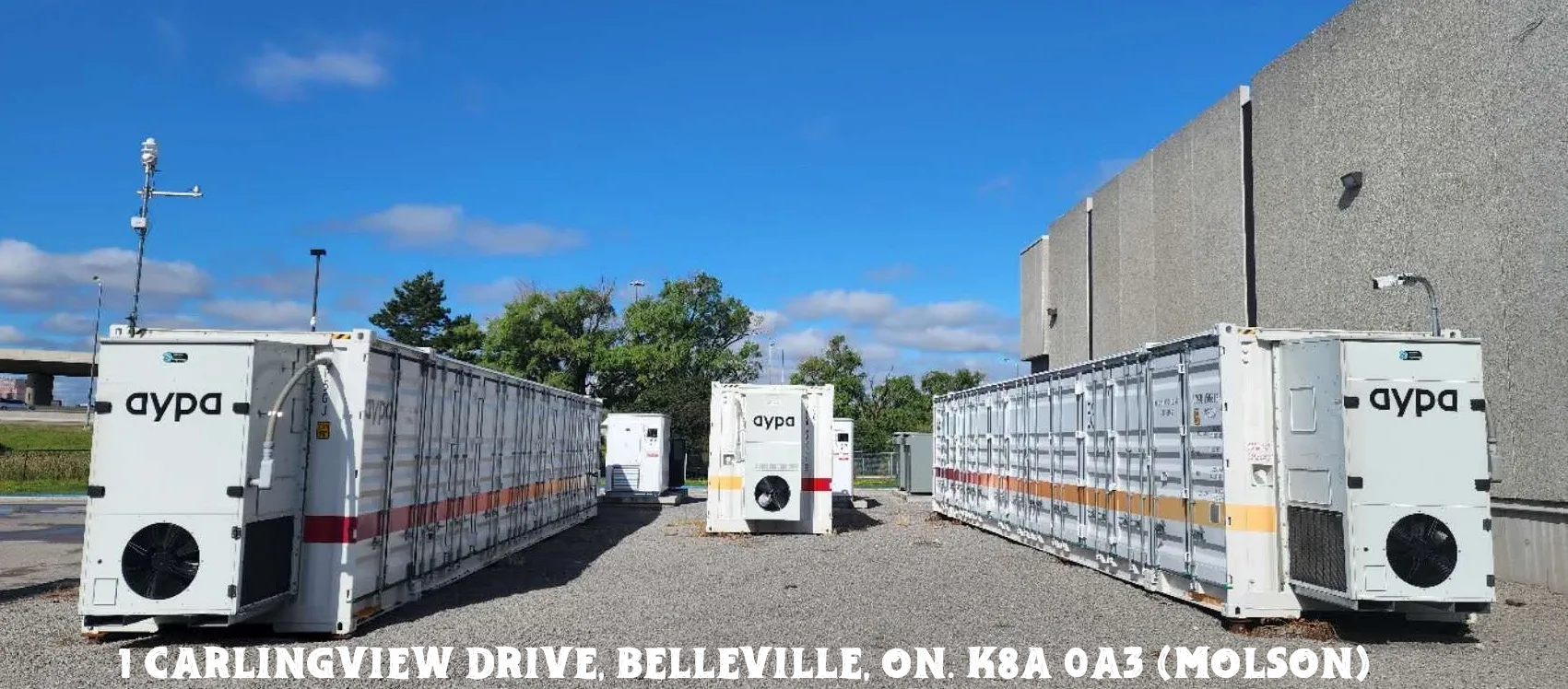 Trucks parked outside a building under a blue sky in Belleville.
