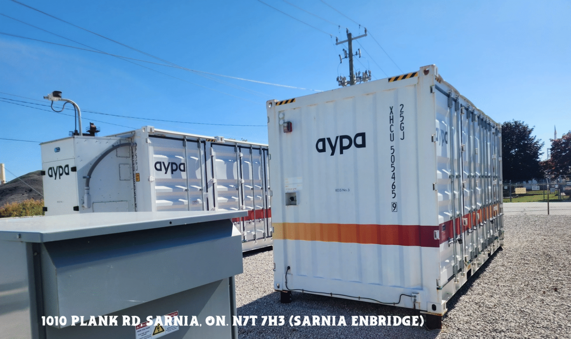 Trucks with 'aypa' branding parked under a clear blue sky on a sunny day.